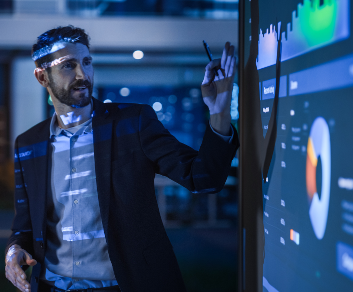 Professional presenting data on a big screen