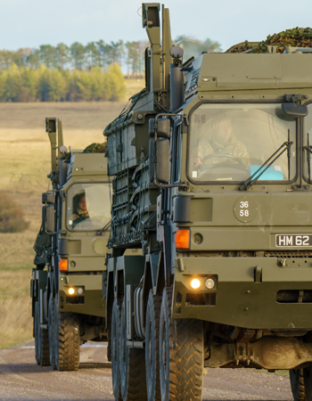 Close-up of two army truck on a country road